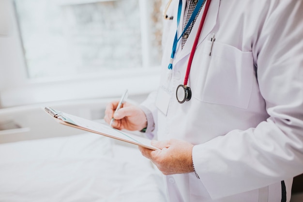 Physician noting down symptoms of a patient