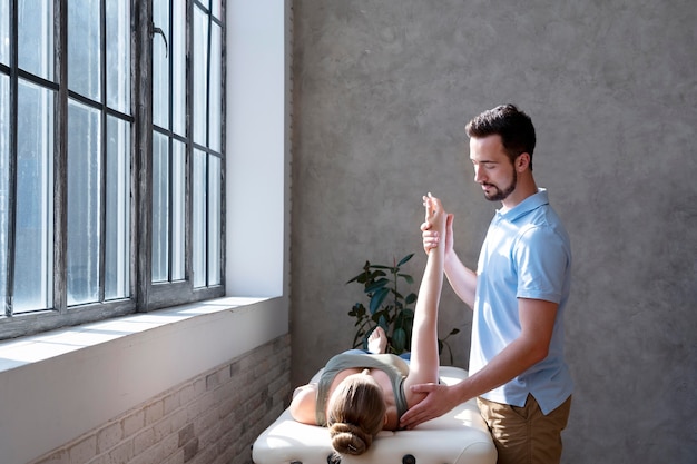 Free photo physiotherapist checking patient medium shot