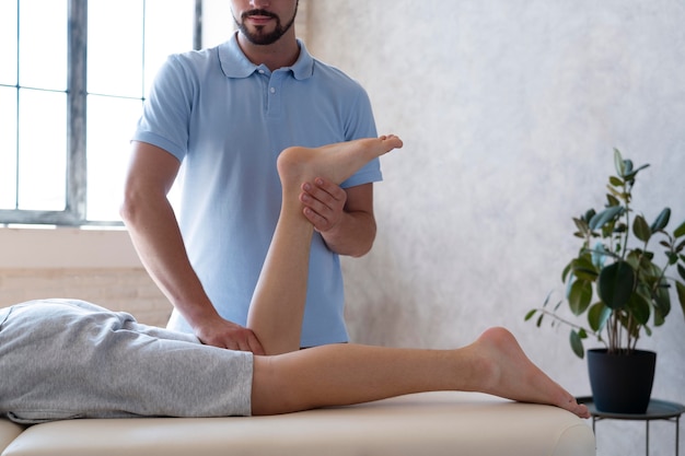 Physiotherapist helping patient close up