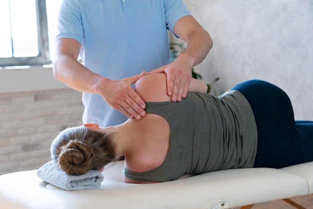 Physiotherapist massaging patient close up