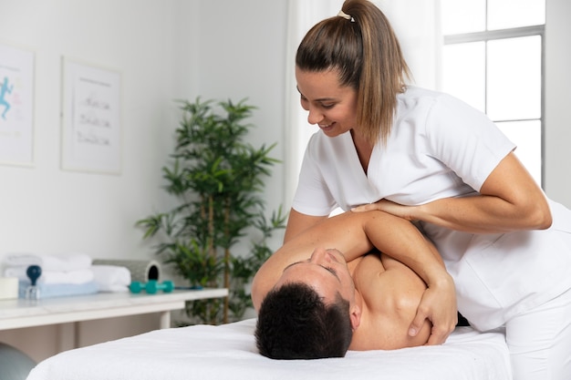 Physiotherapist massaging patient in the office