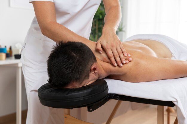 Physiotherapist massaging patient in the office