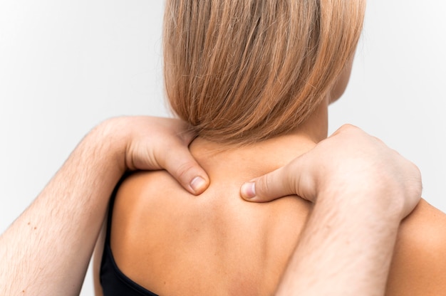 Free photo physiotherapist massaging woman's neck