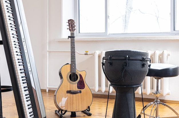 Piano keys and acoustic guitar in the interior of a bright room