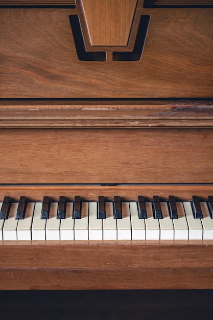 Piano keys on wooden brown musical instrument