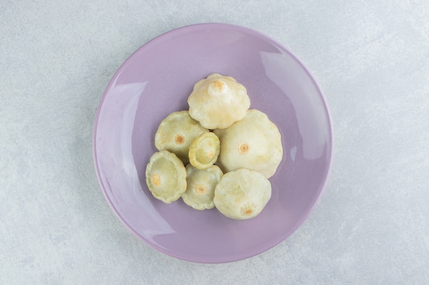 Pickled mini zucchini in a plate   