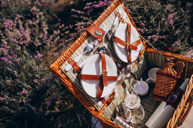 Free photo picnic basket set isolated in a lavander field