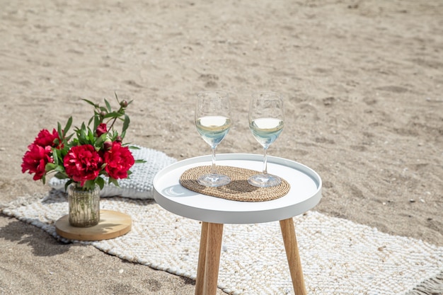 Free Photo picnic with flowers and a glass of champagne. the concept of a holiday.