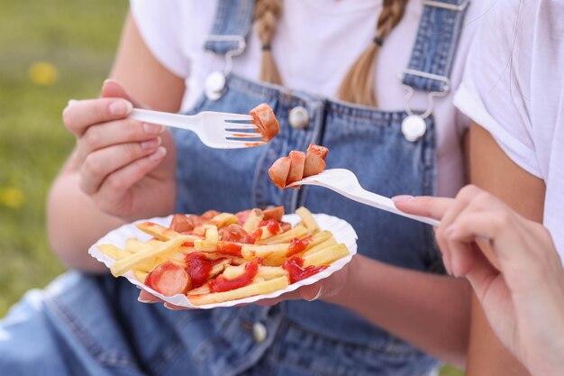 Picnic. Woman is eating food outdoor