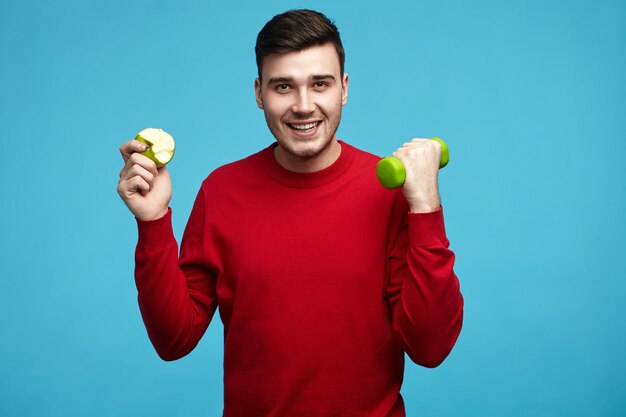 Picture of cheerful cute guy in his twenties working out to loose weight