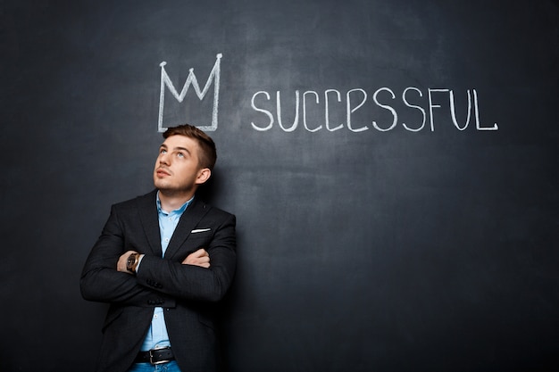 picture of man over blackboard with crown and text successful