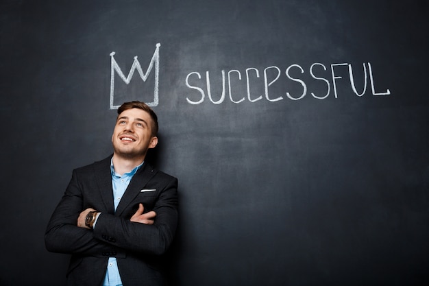 picture of man over blackboard with crown and text successful