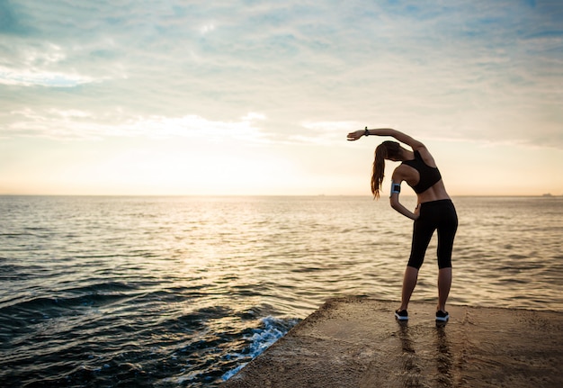 Picture of young beautiful fitness woman makes sport exercises