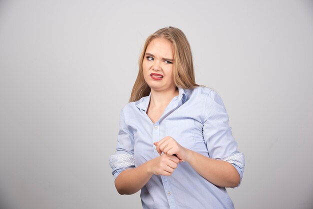 Picture of a young woman model wearing in blue t-shirt and posing