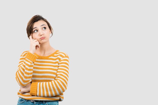 Picture of a young woman standing and thinking