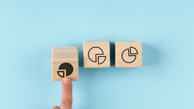 Pie charts on wooden cubes arrangement