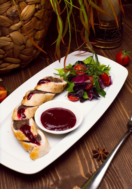 pie with ground beef filling, rolls of puff pastry with meat on plate 