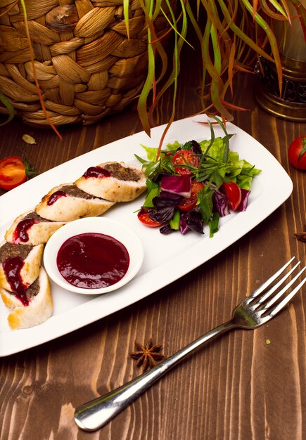 pie with ground beef filling, rolls of puff pastry with meat on plate 