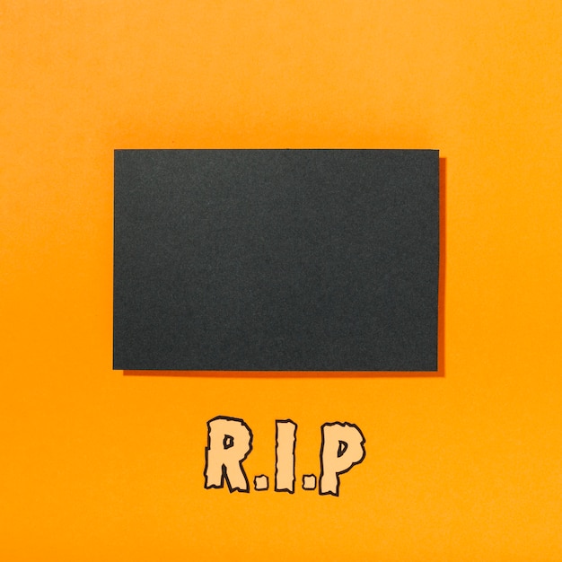 Piece of black paper with R.I.P inscription below