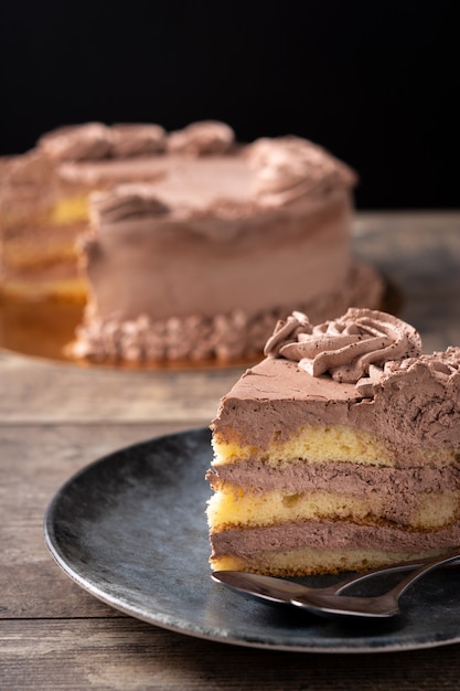 Piece of chocolate truffle cake on wooden table