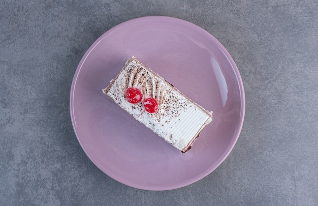 Free photo piece of delicious cake on purple plate.