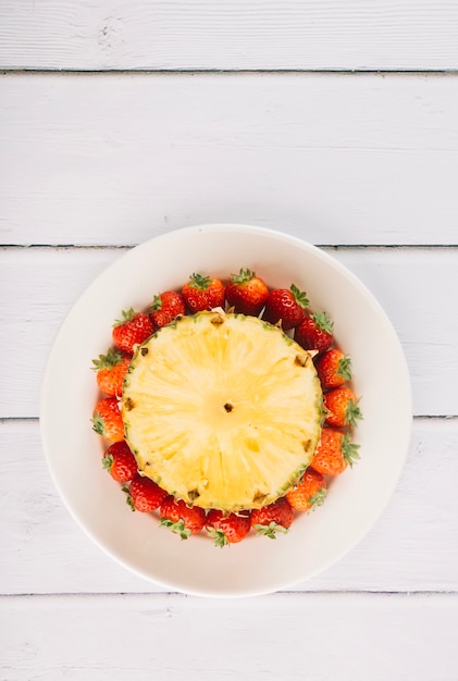 Piece of pineapple on strawberries