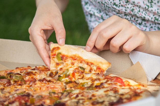 Piece of pizza closeup concept of picnic and relaxation