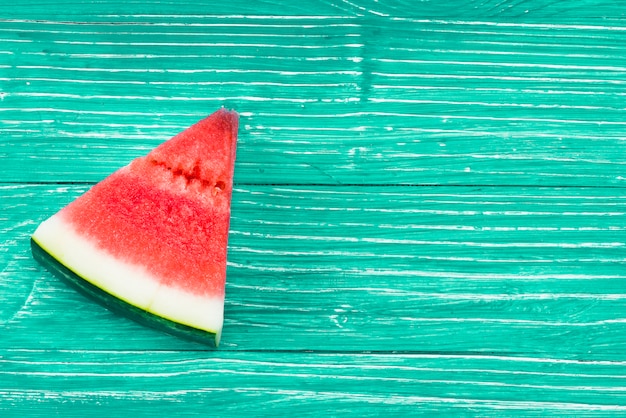 Free Photo piece of  red juicy watermelon on green background