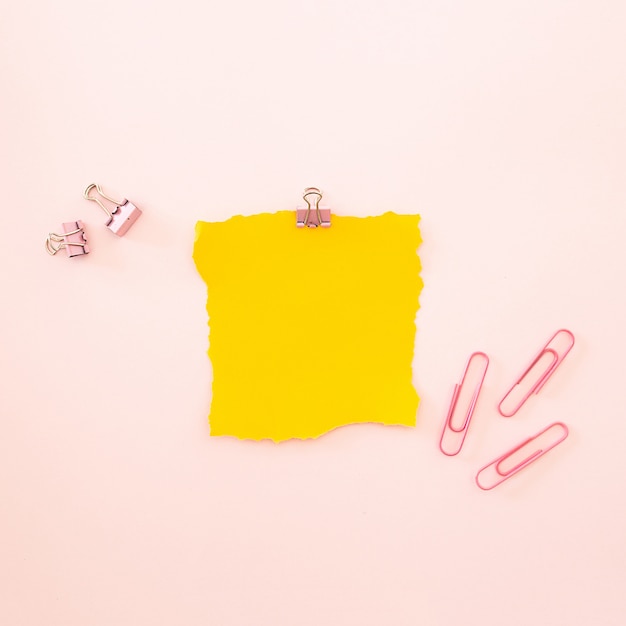 Piece of yellow sheet on a pink background 