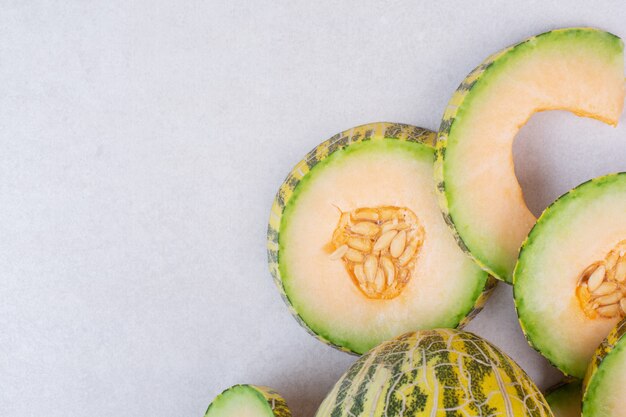 Pieces of green melon on white.