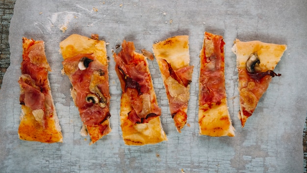 Free photo pieces of pizza on paper