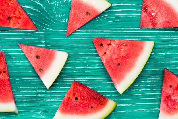 Free photo pieces of red watermelon on green background