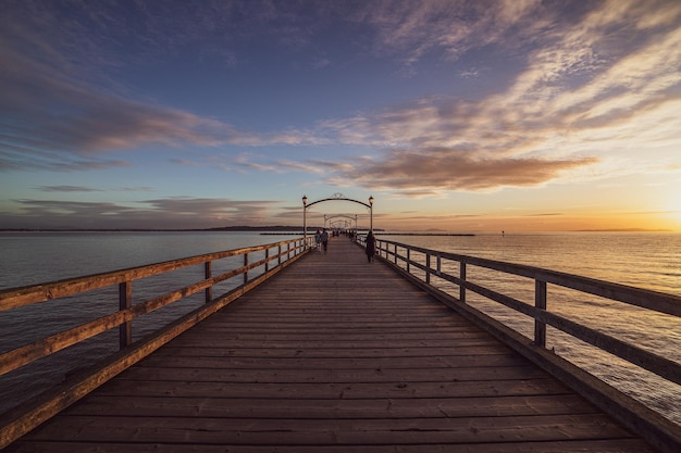 Free photo pier and the blue sea during a scenic sunset