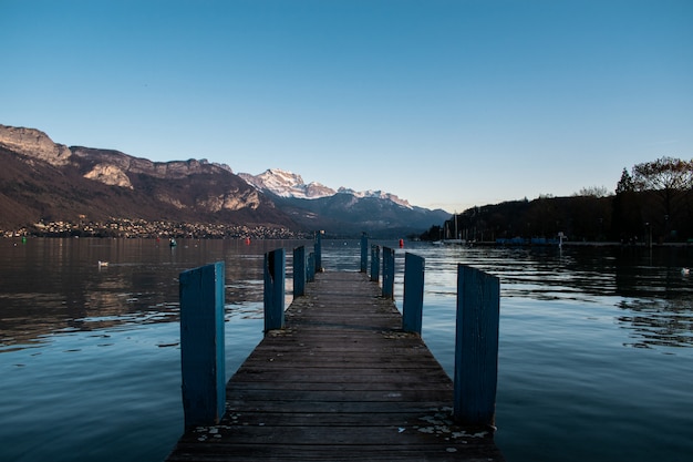 Pier on the lake with reflection during daytime