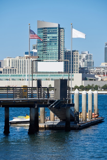 Free photo pier with kayak boats, downtown skyline  in san diego