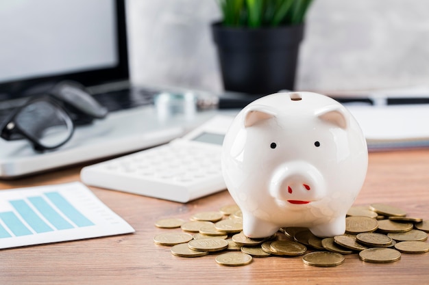 Piggy bank with coins and laptop