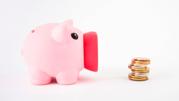 Free Photo piggy bank with coins on table