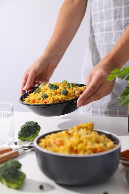 Free Photo pilaf in bowls spices and female hands on light background