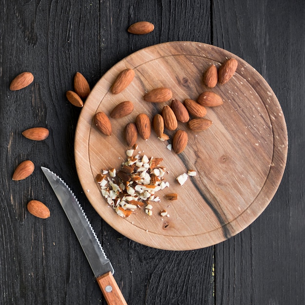 Free Photo pile of almonds on wooden tray