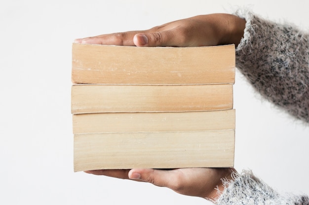 Pile of books between hands