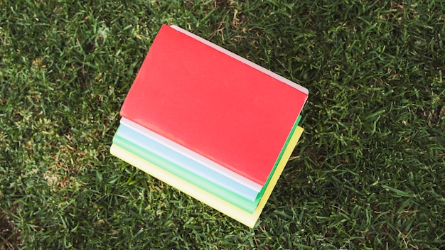 Free Photo pile of colorful books on grass