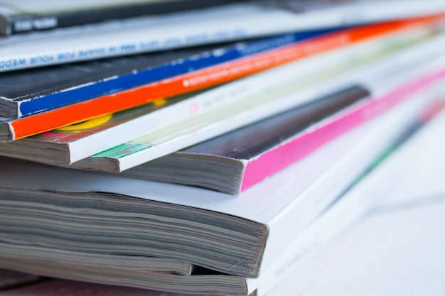 Free photo pile of colorful magazines on a table