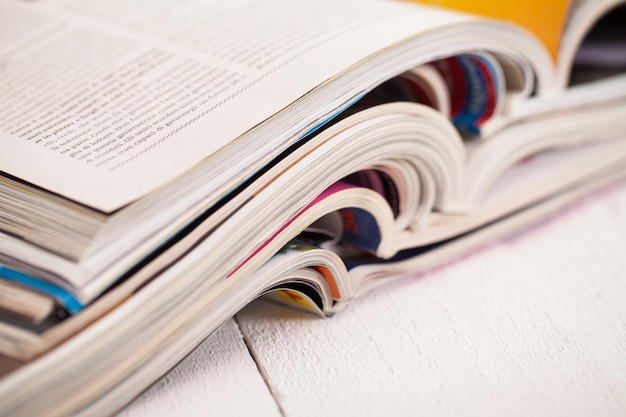 Free photo pile of colorful magazines on a table