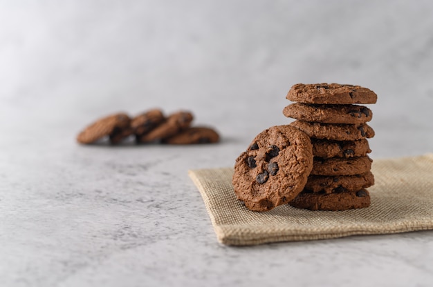 A pile of cookies on a cloth on a wooden table