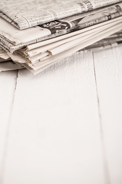 Free photo pile of newspapers on a white table