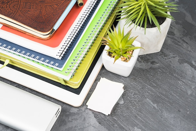 Pile of notebooks on slate background