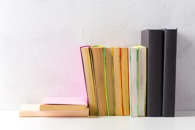 Free photo pile of paperback books on a table