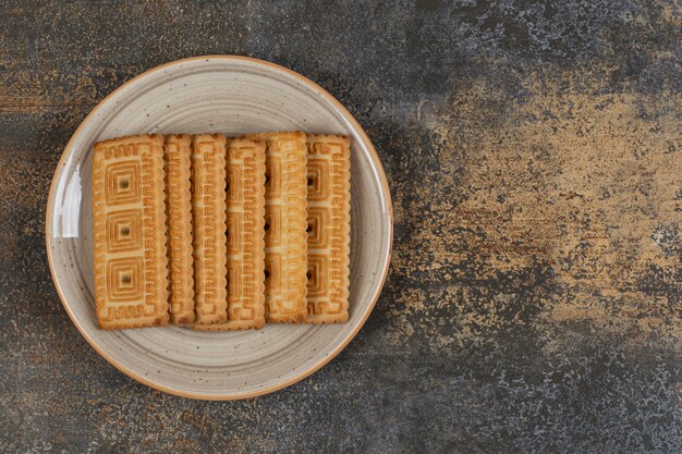 Pile of tasty biscuits on ceramic plate. 