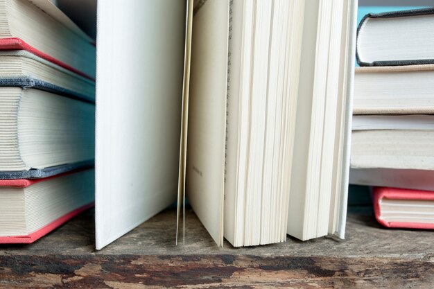 Piles of books on wooden table