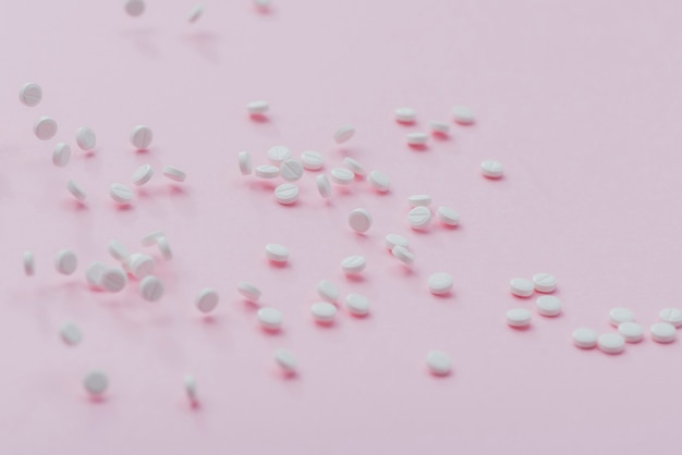 Pills on pink background